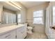 This bathroom features neutral tile, natural light, and a vanity at 1581 Granville Rd, Rock Hill, SC 29732