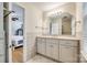 En-suite bathroom with a large mirror, tiled walls, and a vanity with storage space, conveniently located next to the bedroom at 1581 Granville Rd, Rock Hill, SC 29732