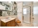 Unique bathroom with magazine-themed wallpaper, a walk-in shower, and a classic vanity at 1581 Granville Rd, Rock Hill, SC 29732