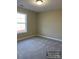 Comfortable bedroom with a neutral palette, soft carpet, and a large window providing natural light at 1669 California Rd, York, SC 29745