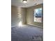 Cozy bedroom with plush carpeting, large window, and ample natural light at 1669 California Rd, York, SC 29745