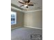 Spacious bedroom features neutral walls, plush carpeting, and a modern ceiling fan at 1669 California Rd, York, SC 29745