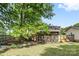 Exterior of the home featuring a large backyard, deck, screened in patio, privacy fence, and landscaping at 206 Pelham Ln, Fort Mill, SC 29715