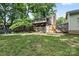 Exterior view of the home featuring a large backyard with mature trees, deck and screened in patio at 206 Pelham Ln, Fort Mill, SC 29715