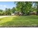 Charming home featuring mature trees and a well-manicured lawn at 206 Pelham Ln, Fort Mill, SC 29715