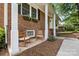 Close-up of a home's inviting front porch with seating, complemented by decorative flower boxes at 206 Pelham Ln, Fort Mill, SC 29715