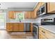 Bright kitchen featuring light wood cabinets, stainless steel appliances and white countertops at 206 Pelham Ln, Fort Mill, SC 29715