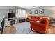 This cozy living room is decorated with an orange couch and soft lighting at 206 Pelham Ln, Fort Mill, SC 29715