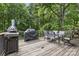 Outdoor patio area with a dining table and chairs surrounded by mature trees at 206 Pelham Ln, Fort Mill, SC 29715
