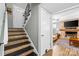 Stairway leading to a living room featuring a stone fireplace and TV at 206 Pelham Ln, Fort Mill, SC 29715