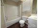 This bathroom includes a tub-shower combo, single sink vanity, and dark floor at 2105 Killarney Pl, Charlotte, NC 28262