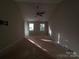 This spacious bedroom includes a ceiling fan, carpetless floors, and sunny windows at 2105 Killarney Pl, Charlotte, NC 28262