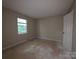 This bedroom has a carpetless floor and a bright window at 2105 Killarney Pl, Charlotte, NC 28262