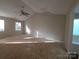 This is a spacious bedroom with vaulted ceilings, carpetless floor and large windows at 2105 Killarney Pl, Charlotte, NC 28262