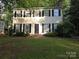 Inviting two-story home with black shutters and well-manicured lawn, offering classic charm and curb appeal at 2105 Killarney Pl, Charlotte, NC 28262