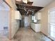 This kitchen requires renovation, missing ceiling and damaged walls, providing opportunity for a custom design at 2105 Killarney Pl, Charlotte, NC 28262
