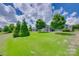 Large, green backyard with mature trees and lush landscaping, offering a private and serene outdoor space at 217 Barberry Dr, Belmont, NC 28012