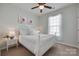 Charming bedroom with a ceiling fan, white bedding, and bright natural light from the window at 217 Barberry Dr, Belmont, NC 28012