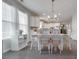 Bright dining area features a table with white chairs and a chandelier at 217 Barberry Dr, Belmont, NC 28012