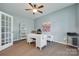 Bright home office with hardwood floors, ceiling fan, and a white contemporary desk at 217 Barberry Dr, Belmont, NC 28012