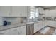 Close-up of the kitchen showing granite countertops, subway tile backsplash, and stainless steel appliances at 217 Barberry Dr, Belmont, NC 28012