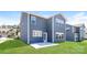 Exterior of a blue two-story home featuring a well-maintained backyard with a concrete patio at 2327 Glenway Trail Ct, Pineville, NC 28134