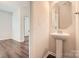 Half bathroom featuring stylish mirror, pedestal sink, and attractive floor tile at 2327 Glenway Trail Ct, Pineville, NC 28134