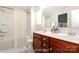 Virtually staged bathroom featuring a double vanity, large mirror and shower-tub combination at 2327 Glenway Trail Ct, Pineville, NC 28134