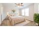 Virtual staged bedroom with a large window, a ceiling fan, and neutral colors for a relaxing retreat at 2327 Glenway Trail Ct, Pineville, NC 28134