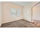 Cozy carpeted bedroom with bright natural light from the window, and white door at 2327 Glenway Trail Ct, Pineville, NC 28134