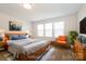 Virtual staged bedroom with three windows, and comfortable furniture that creates a cozy retreat at 2327 Glenway Trail Ct, Pineville, NC 28134