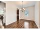 Bright dining room featuring hardwood floors and stylish chandelier lighting at 2327 Glenway Trail Ct, Pineville, NC 28134