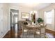 This staged dining room includes a wooden table set for four, and a stylish wine rack at 2327 Glenway Trail Ct, Pineville, NC 28134