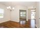 Dining room featuring dark wood floors and chandelier lighting fixture above at 2327 Glenway Trail Ct, Pineville, NC 28134