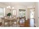 The staged dining room features a round wooden table set for six, and stylish decor at 2327 Glenway Trail Ct, Pineville, NC 28134