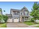 Charming two-story home with a well-manicured lawn, a two car garage and inviting front porch at 2327 Glenway Trail Ct, Pineville, NC 28134