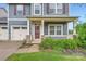 Charming two-story home with a welcoming front porch and well-maintained lawn at 2327 Glenway Trail Ct, Pineville, NC 28134