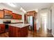 Kitchen with cherry cabinets, a large island, stainless steel appliances, and light-filled dining area at 2327 Glenway Trail Ct, Pineville, NC 28134