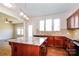 Well-lit kitchen features an island with granite counters, wood cabinets and stainless steel appliances at 2327 Glenway Trail Ct, Pineville, NC 28134