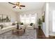 Virtual staged living room featuring a comfortable white sofa, chairs, and a neutral rug at 2327 Glenway Trail Ct, Pineville, NC 28134