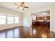 Bright living room with hardwood floors adjacent to a modern kitchen with stainless steel appliances at 2327 Glenway Trail Ct, Pineville, NC 28134