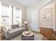 Virtually staged living room showcasing a modern sofa, neutral decor, and ample natural light at 2327 Glenway Trail Ct, Pineville, NC 28134