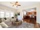 Virtual staged Living room and Kitchen feature plenty of natural light and an open floor plan at 2327 Glenway Trail Ct, Pineville, NC 28134