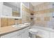 This bathroom features a toilet, bathtub, tiled walls, and a sink vanity with countertop and mirror at 2336 32Nd Ne St, Hickory, NC 28601