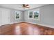 Bright bedroom featuring gleaming wood floors, neutral paint, a ceiling fan and abundant natural light at 2336 32Nd Ne St, Hickory, NC 28601