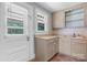 Compact kitchen featuring tan cabinets, laminate countertops and convenient access to the backyard at 2336 32Nd Ne St, Hickory, NC 28601