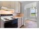 Cozy kitchen with cream colored cabinets, tiled countertops, and a view of the dining room at 2336 32Nd Ne St, Hickory, NC 28601