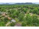 Aerial view of a neighborhood nestled among lush trees and rolling hills at 2401 Woodleaf Dr, Gastonia, NC 28052