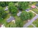 Aerial view of residential neighborhood showcasing mature trees, green lawns, driveways, and a lovely backyard at 2401 Woodleaf Dr, Gastonia, NC 28052