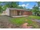 Backyard featuring an open patio with exposed brick and a covered structure at 2401 Woodleaf Dr, Gastonia, NC 28052